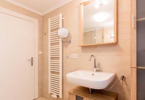 a bathroom with a sink and a mirror at Ferienwohnung Onkel Toms Hütte in Scharbeutz