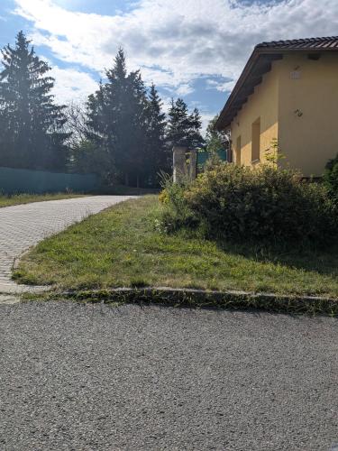 a road next to a house with a building at 386 Apartman in Písek