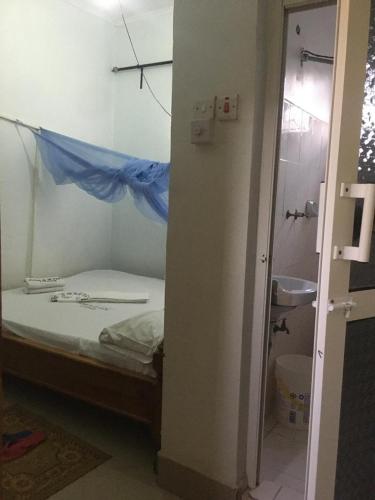 a bedroom with a bed with a blue sheet on it at Amazon half london in Boma la Ngombe