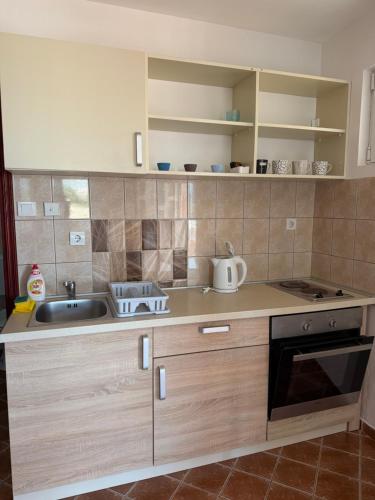 a kitchen with a sink and a stove at Villa Lila in Utjeha