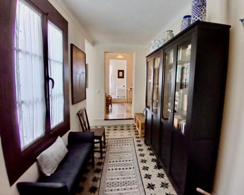 a living room with a couch and a cabinet at Número 9 in Medina Sidonia