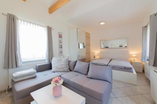 a living room with a couch and a bed at Ferienwohnung 3 Haus Meeresrauschen - Bungalow in Haffkrug