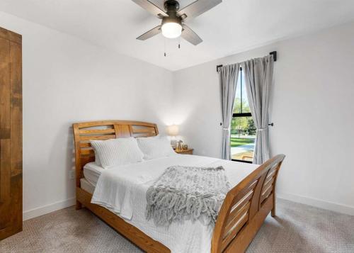 a bedroom with a bed with a ceiling fan and a window at The Farmhouse in Darby