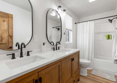 a bathroom with a sink and a mirror and a toilet at The Farmhouse in Darby