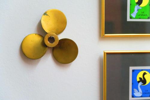 a wall with a wooden flower on a wall at Piccolo Hotel in Locarno