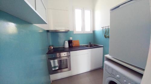 a small kitchen with a sink and a stove at KYMA Apartments - Athens Acropolis 6 in Athens