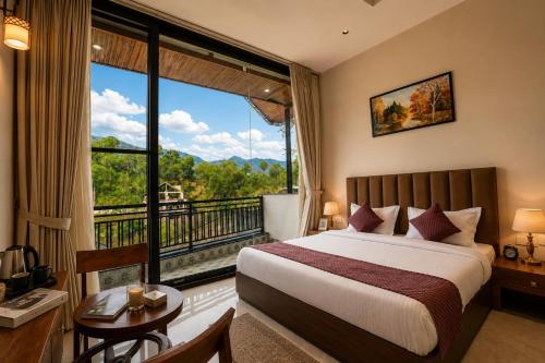 a hotel room with a bed and a large window at Minara Meadows Kasauli in Dharampur