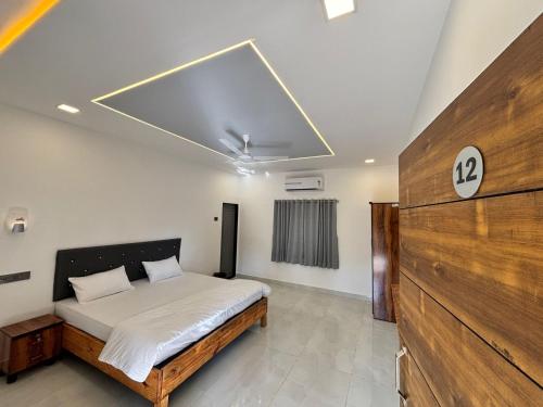 a bedroom with a bed in a room at Indraprastha Cottage in Alibaug
