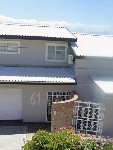 a house with a silver tin roof on it at Memento Vivere in Mossel Bay