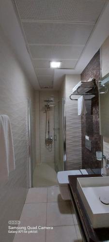 a bathroom with a shower and a toilet and a sink at Grand Hotel Van in Van