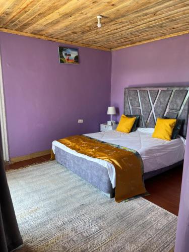 a bedroom with two beds with yellow pillows at I love Amboseli in Kimana