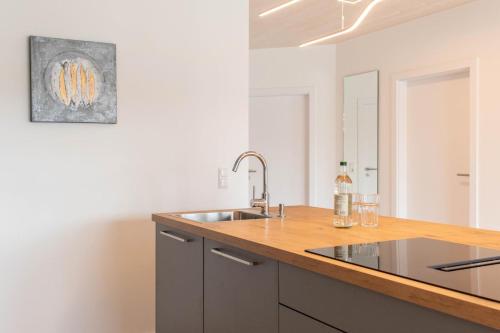 a kitchen with a sink and a wooden counter top at Ferienhaus Eastside - Niendorf in Häven