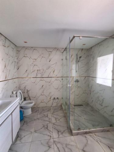 a bathroom with a glass shower and a toilet at Villa Anfa in Casablanca