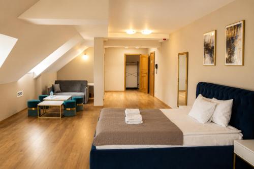 a living room with a bed and a couch at Hotel Vinnica in Wieliczka