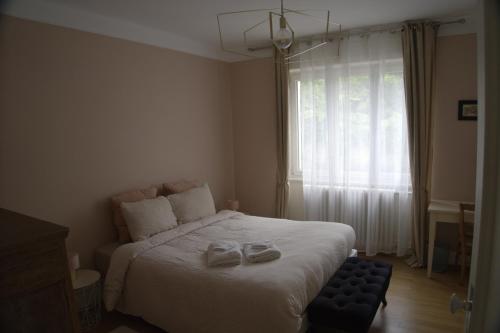 a bedroom with a bed with two slippers on it at Yapot in Colmar