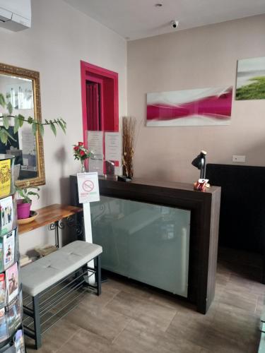 a room with a counter with a bench and paintings at Hôtel Montsouris Orléans in Paris