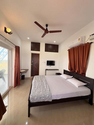 a bedroom with a bed and a ceiling fan at Ocean Kala Crest in Cheyūr