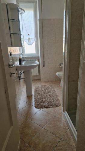ein Badezimmer mit Waschbecken, Toilette und Fenster in der Unterkunft Rapallo Riviera in Rapallo