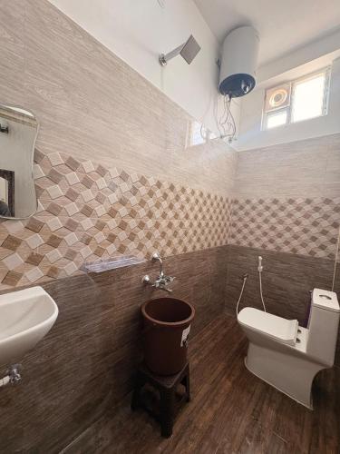 a bathroom with a toilet and a sink at Ocean Kala Crest in Cheyūr