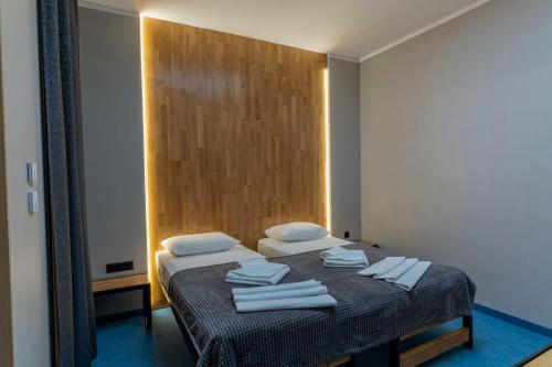a bedroom with a bed with towels on it at O'clock bed & SPA in Burgas