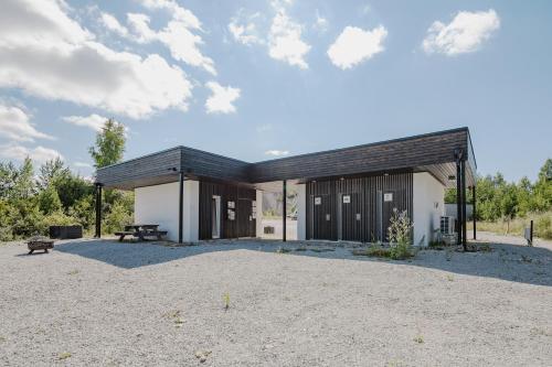 a building with a picnic table in front of it at RUMMU Quarry Houses in Rummu