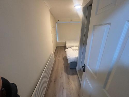a small room with a small bed and a door at Newbridge house in Newbridge