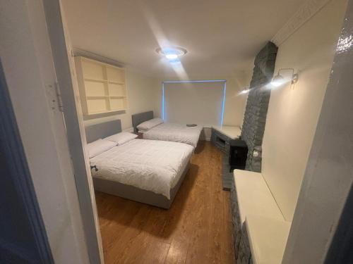 a small bedroom with two beds and a mirror at Newbridge house in Newbridge