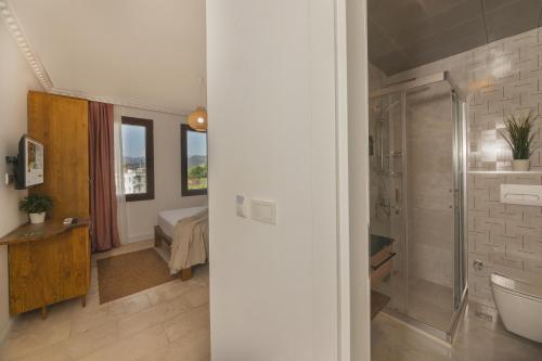 a bathroom with a shower and a toilet in a room at Kiraz Vela Selimiye in Marmaris