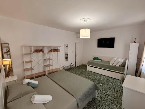a bedroom with two beds and a tv in it at Coramino in Chioggia