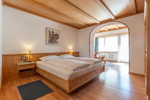 a bedroom with a large bed in a room at Hotel Bären in St. Moritz
