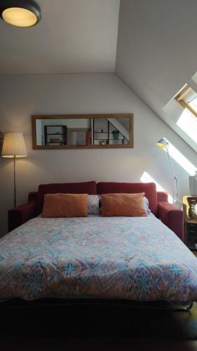 a bedroom with a large bed with a window at Ático LA FLOR DEL SOL in Canfranc