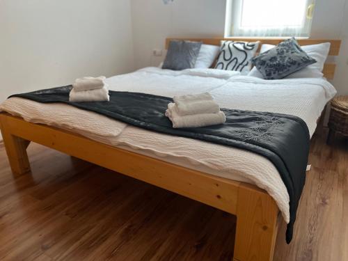 a bed with two towels on top of it at Johanna Apartman in Harkány