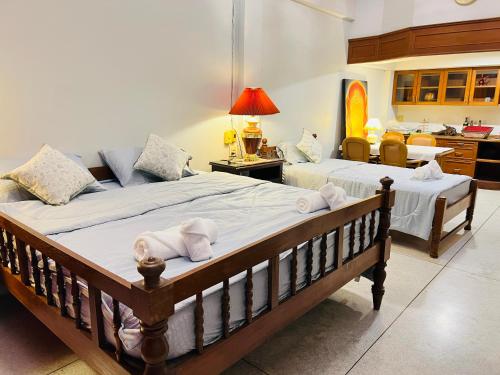 a bedroom with two beds with towels on them at Baan Bangrak Home in Bang Rak