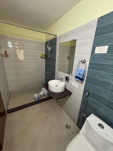 a bathroom with a sink and a toilet at The Humble Abode in kolkata