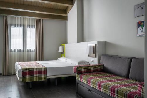 a hotel room with two beds and a couch at Estival Cristina in Pas de la Casa