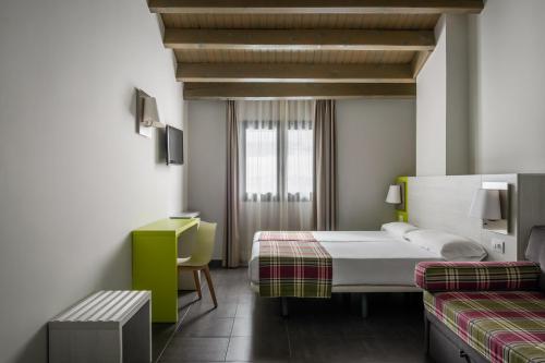a hotel room with two beds and a window at Estival Cristina in Pas de la Casa