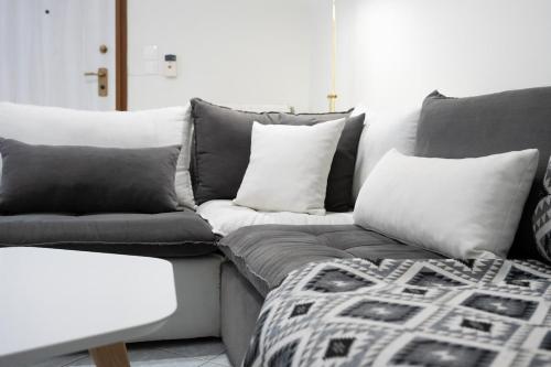 a living room with a couch with pillows at Pallantides Residence in Pallini