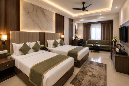 a hotel room with two beds and a television at Hotel Aviora Plaza By Almati Group Near IGI Delhi Airport With - Free Airport Pickup in New Delhi