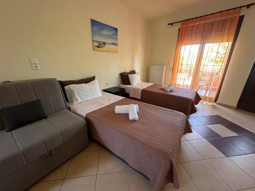 a living room with two beds and a couch at Morfili Villa in Limenaria