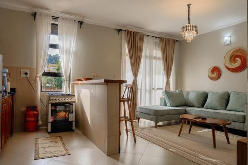 a living room with a couch and a stove at Ssentongo Properties Limited in Kampala
