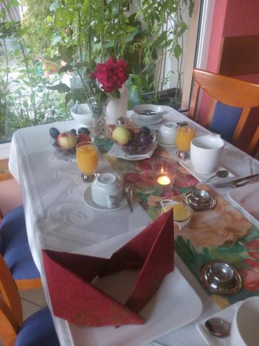 a table with a white table cloth with fruit and candles at Pension Jana Tatrovice in Tatrovice