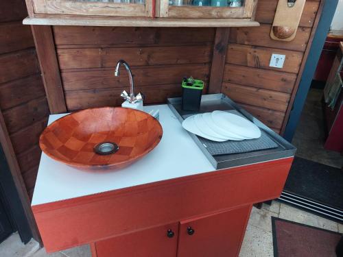a bathroom with a wooden sink on a counter at L'Oreiller du Maïdo in Saint-Paul