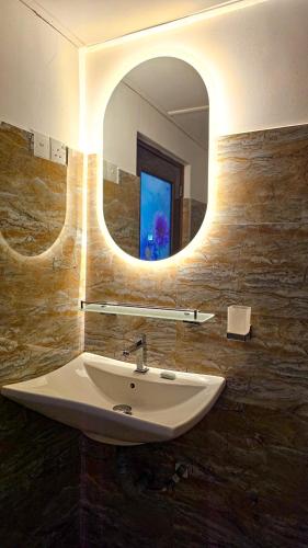 a bathroom with a sink and a mirror at Samson & Ruby Villa in Weligama