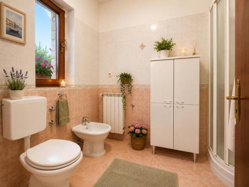 a bathroom with a toilet and a sink at Inter-nautika doo in Jezera