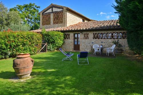 a house with a yard with chairs and a table at Betulla C in San Gimignano