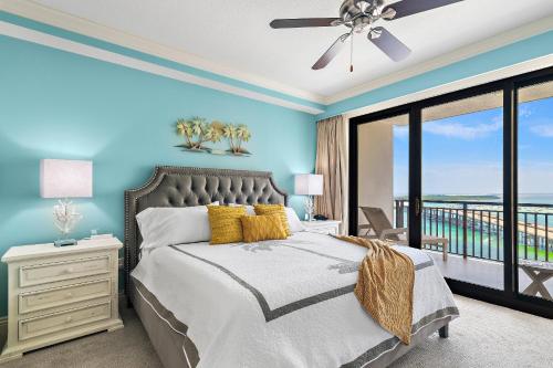 a bedroom with a bed and a balcony at Breathtaking Views Emerald Grande 3BR,2BA 904E in Destin