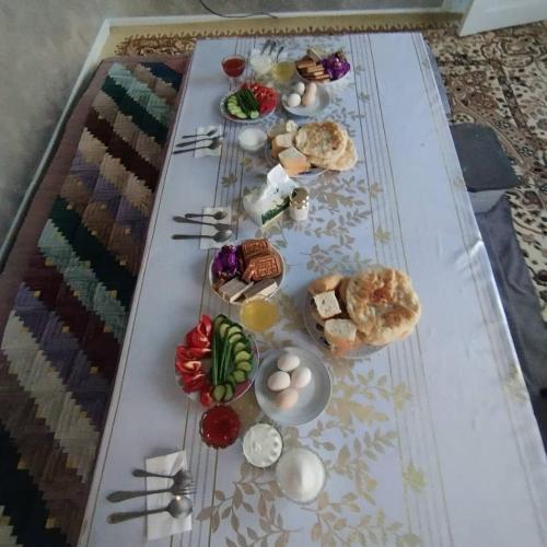 a table topped with different types of food on it at Altyn-Bulak in Kemin