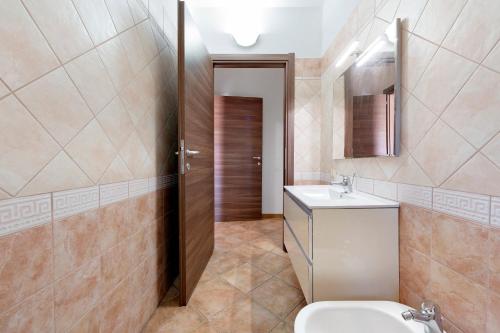 a bathroom with a toilet and a sink at Daluef Alloggi in Assemini