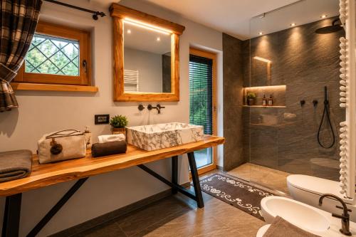 a bathroom with a sink and a shower at Chalet degli Abeti by AMA Val di Fassa in Campitello di Fassa