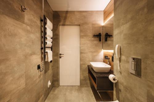 a bathroom with a sink and a toilet at ETERNA HOTEL & SPA by Fomich in Palyanytsya